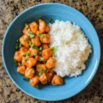 gluten free instant pot orange chicken with white rice in a blue bowl