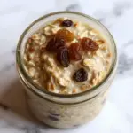 mason jar with overnight oats with raisins on top